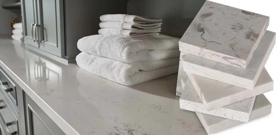 Light countertop with stacked towels and a display of quartz samples