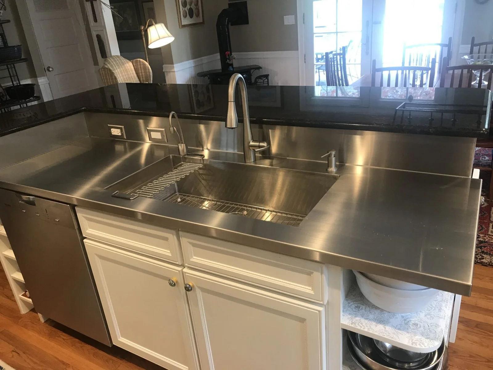 Stainless steel countertop with an integrated double sink and raised backsplash