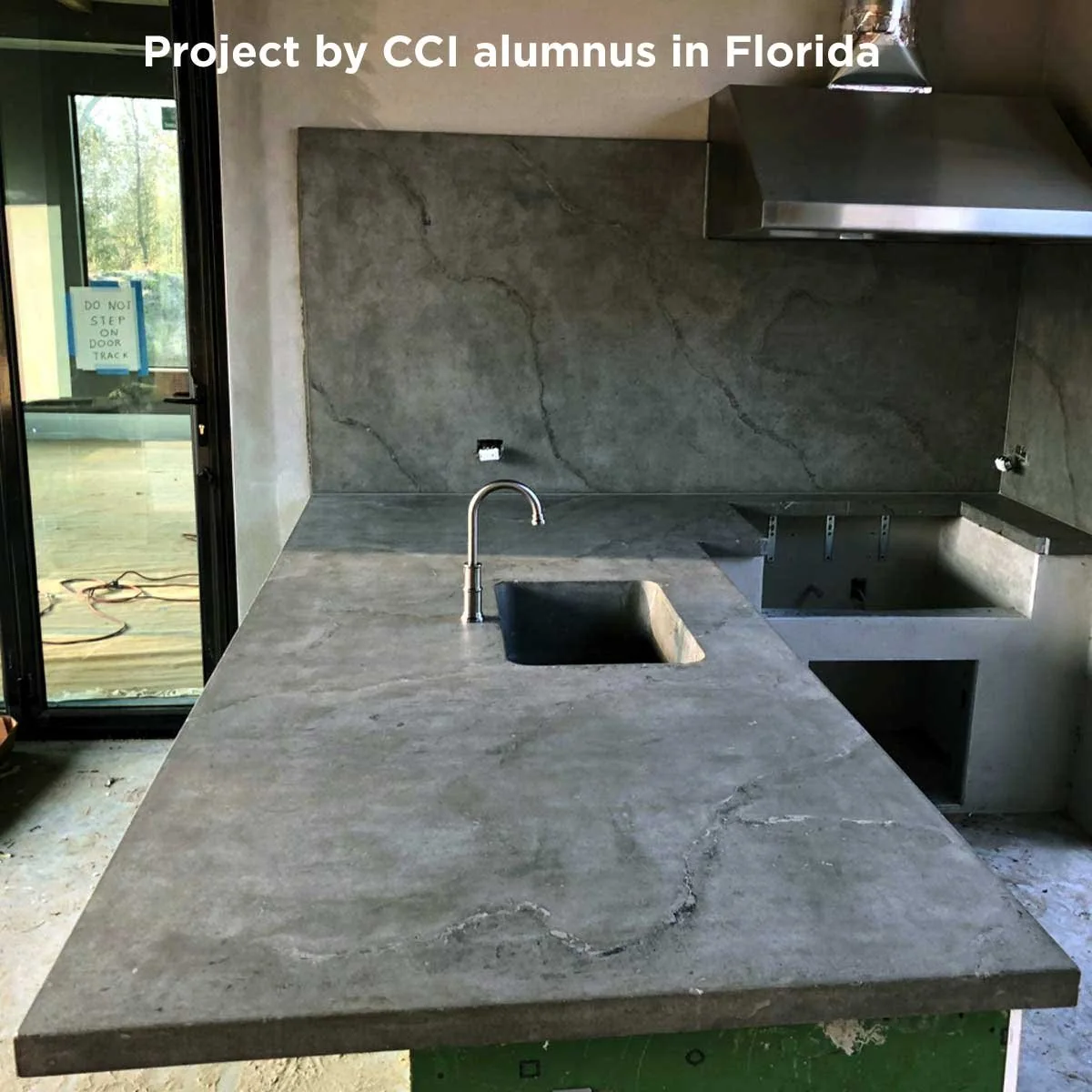 Outdoor concrete countertop with a sink and built-in cooking area