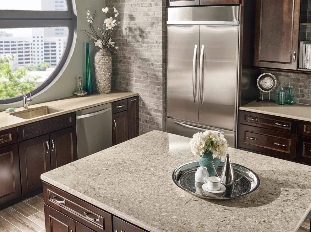 Kitchen island with a beige patterned countertop and dark wood cabinets