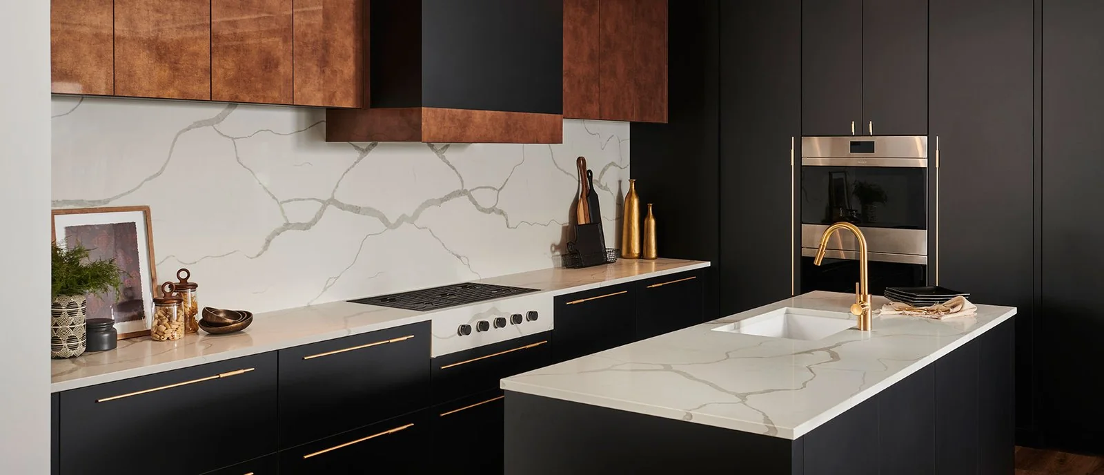 White veined island and matching backsplash beside dark kitchen cabinets