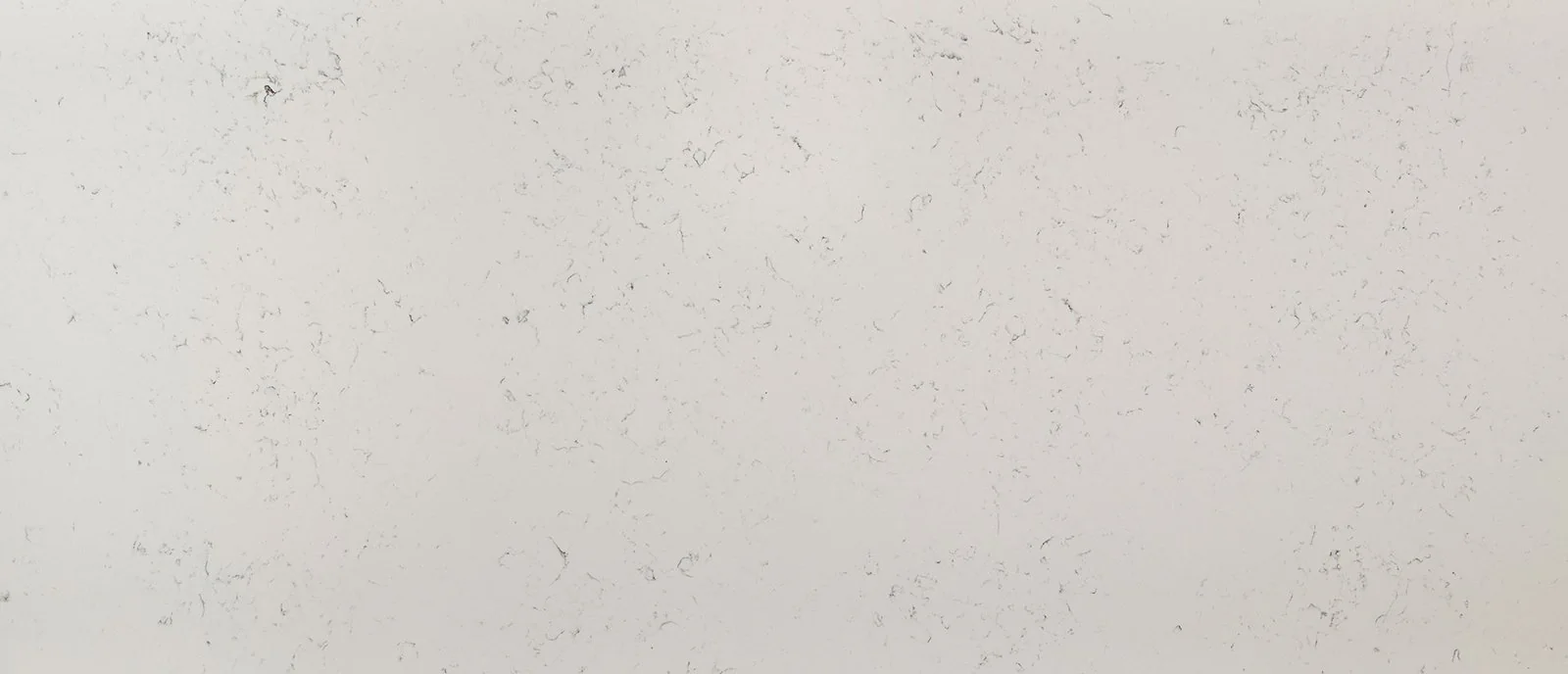 Close-up of warm white quartz with faint clouding and delicate markings