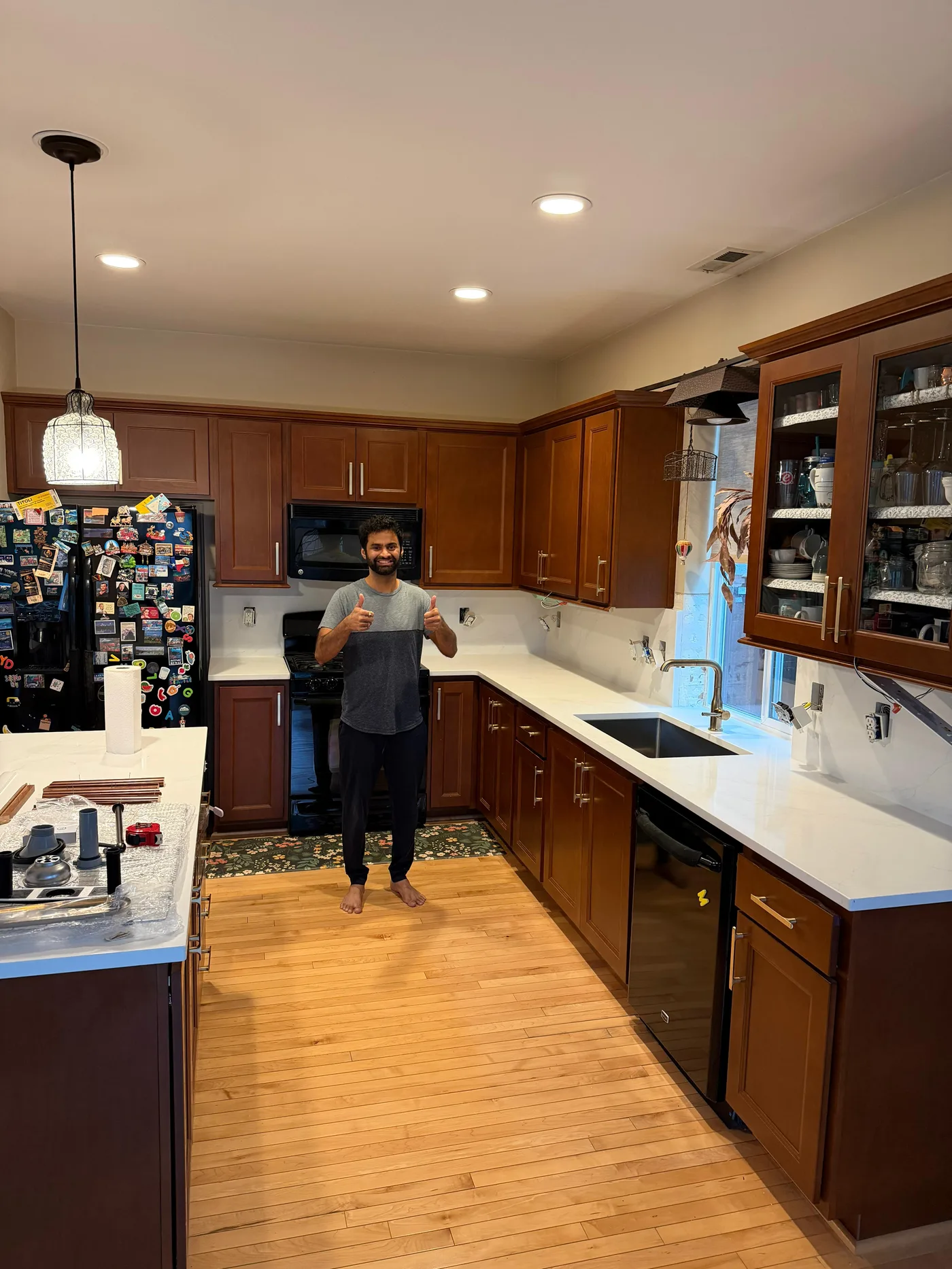 Homeowner giving a thumbs-up beside their finished Top Granite countertop