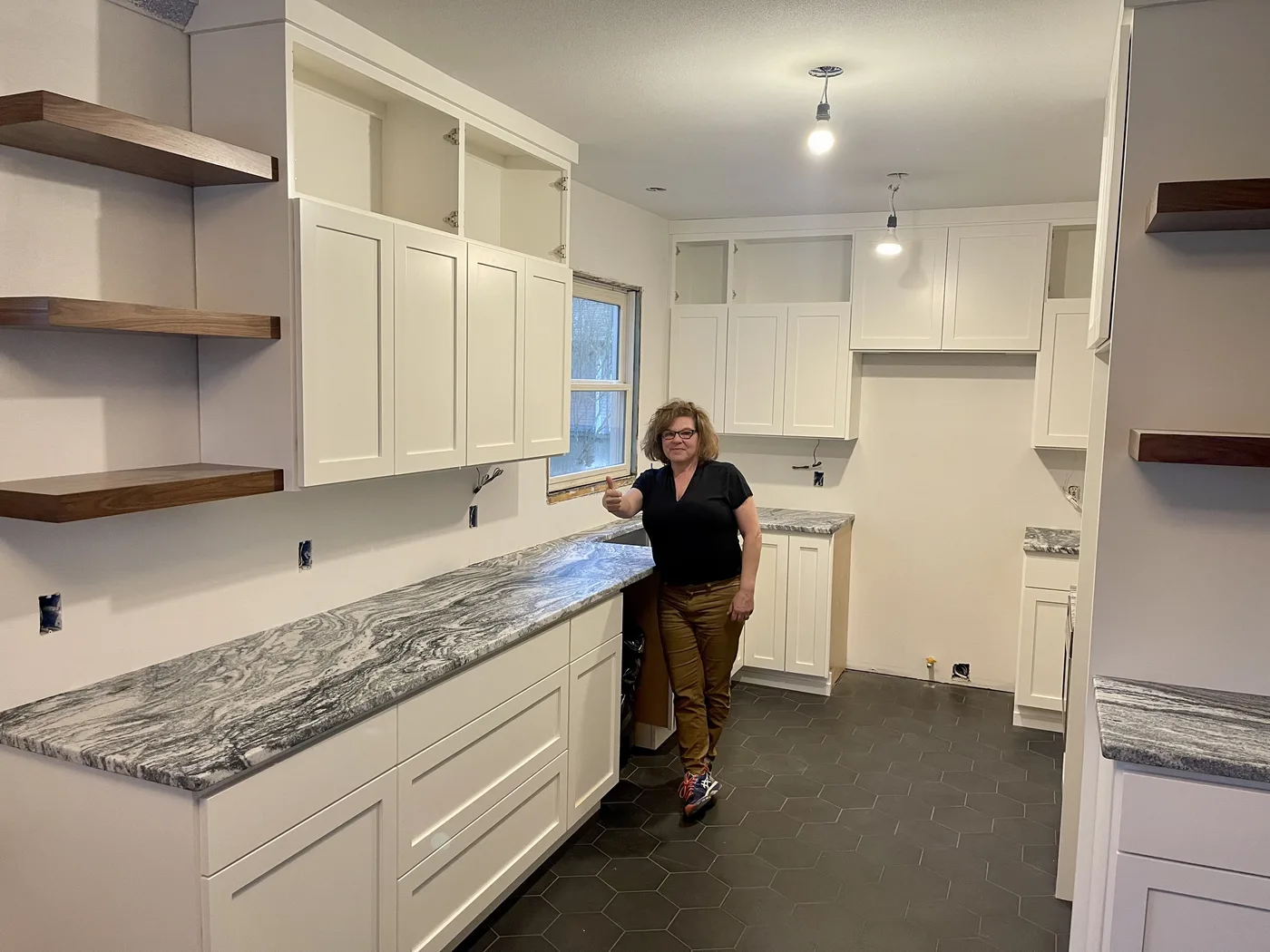 Homeowner giving a thumbs-up beside their finished Top Granite countertop