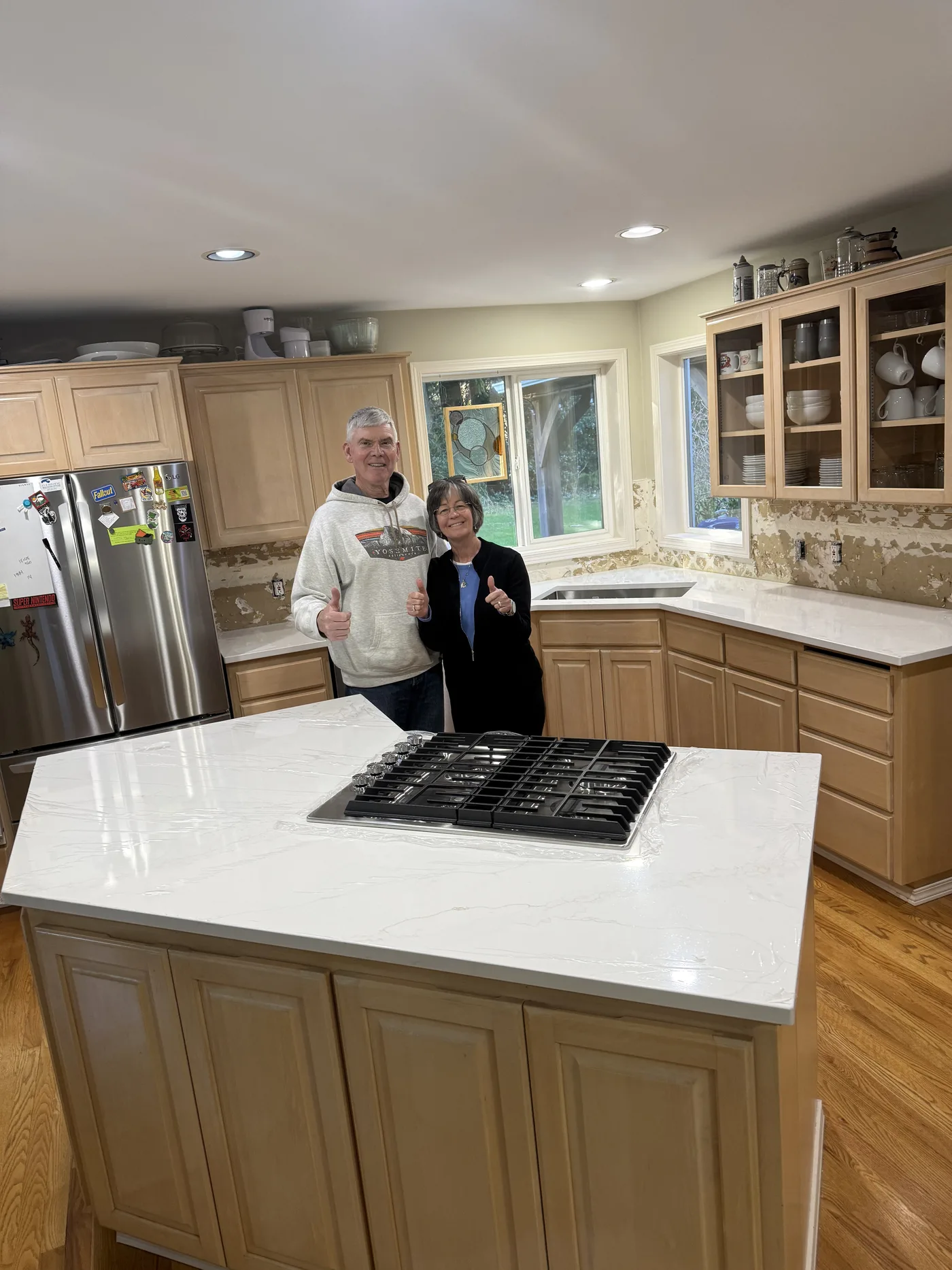 Homeowner giving a thumbs-up beside their finished Top Granite countertop