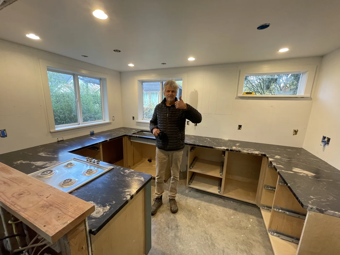 Homeowner giving a thumbs-up beside their finished Top Granite countertop