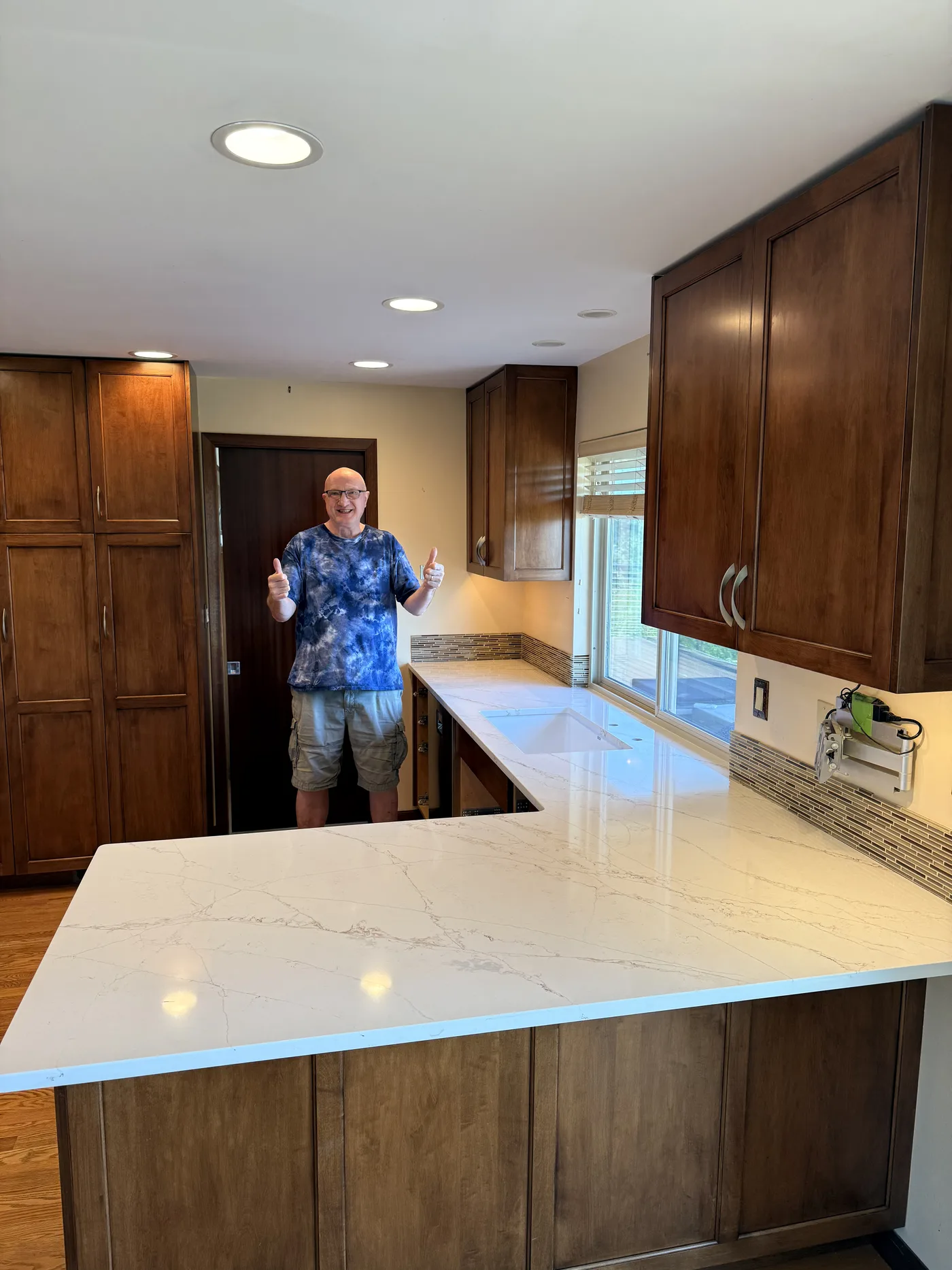 Homeowner giving a thumbs-up beside their finished Top Granite countertop