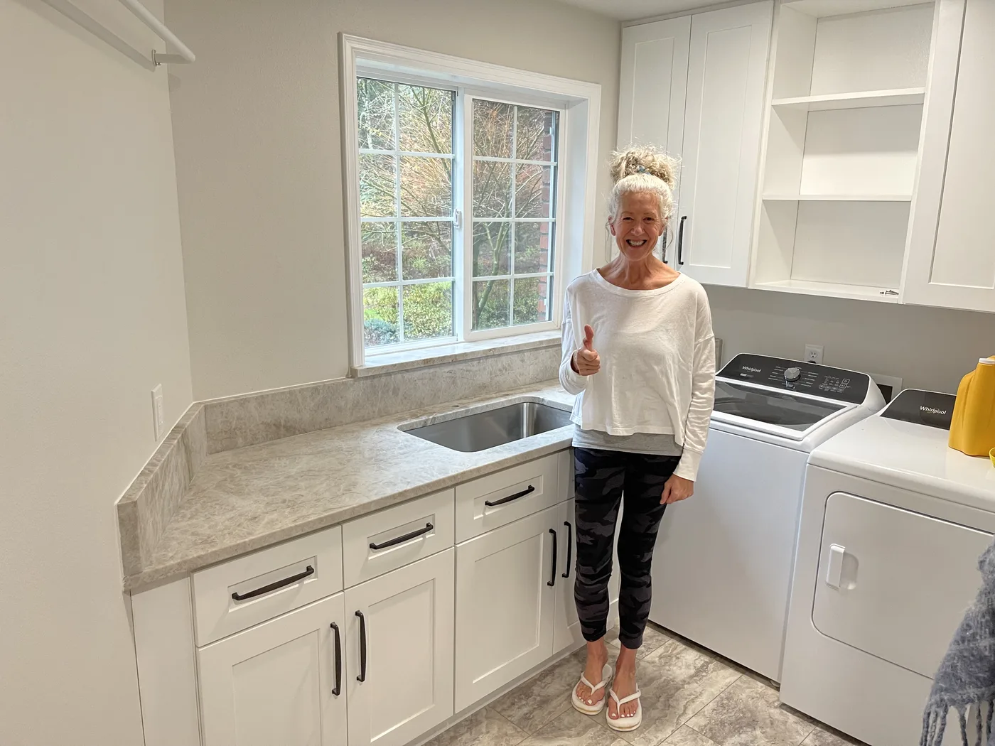 Homeowner giving a thumbs-up beside their finished Top Granite countertop