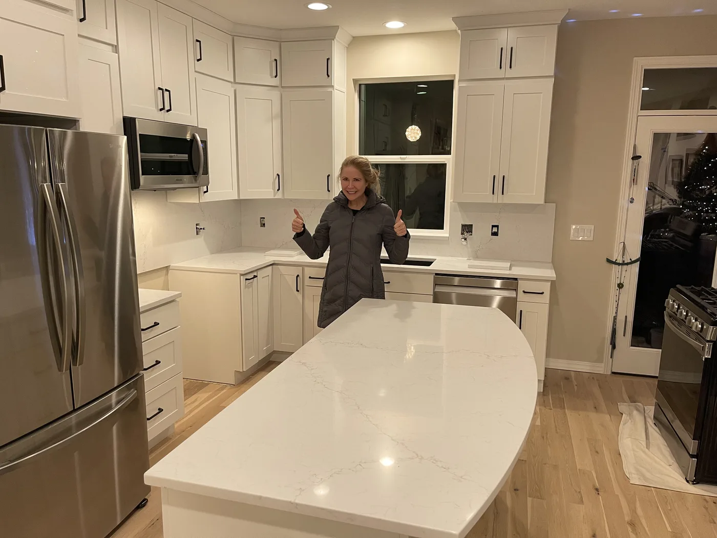 Homeowner giving a thumbs-up beside their finished Top Granite countertop