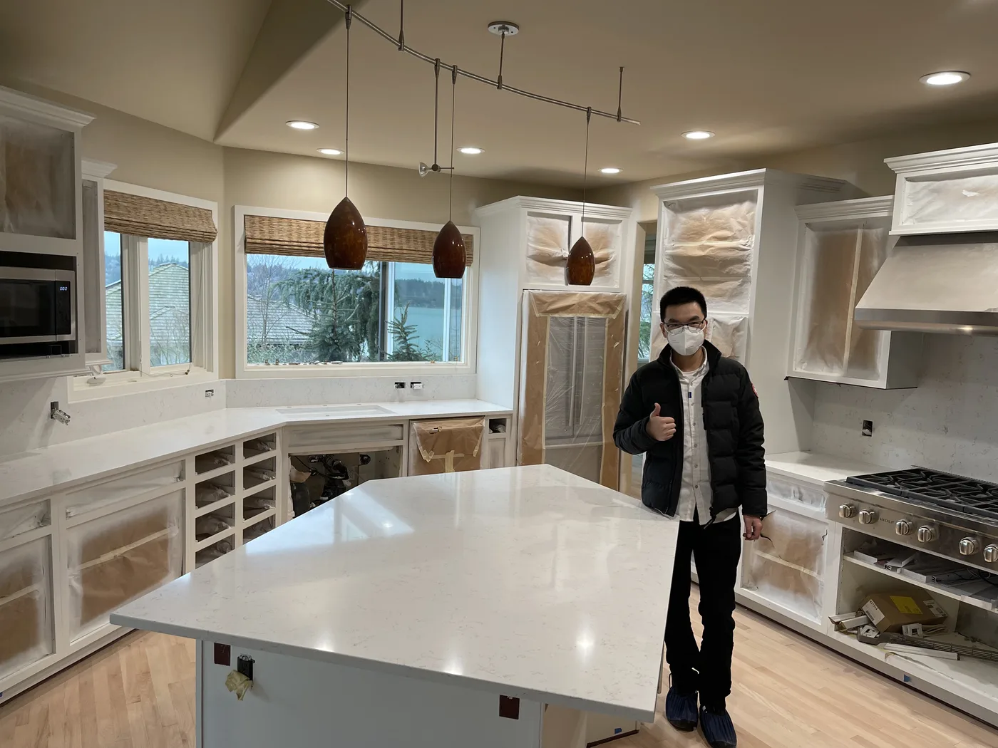 Homeowner giving a thumbs-up beside their finished Top Granite countertop