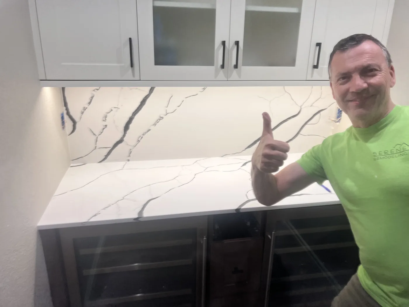 Homeowner giving a thumbs-up beside their finished Top Granite countertop