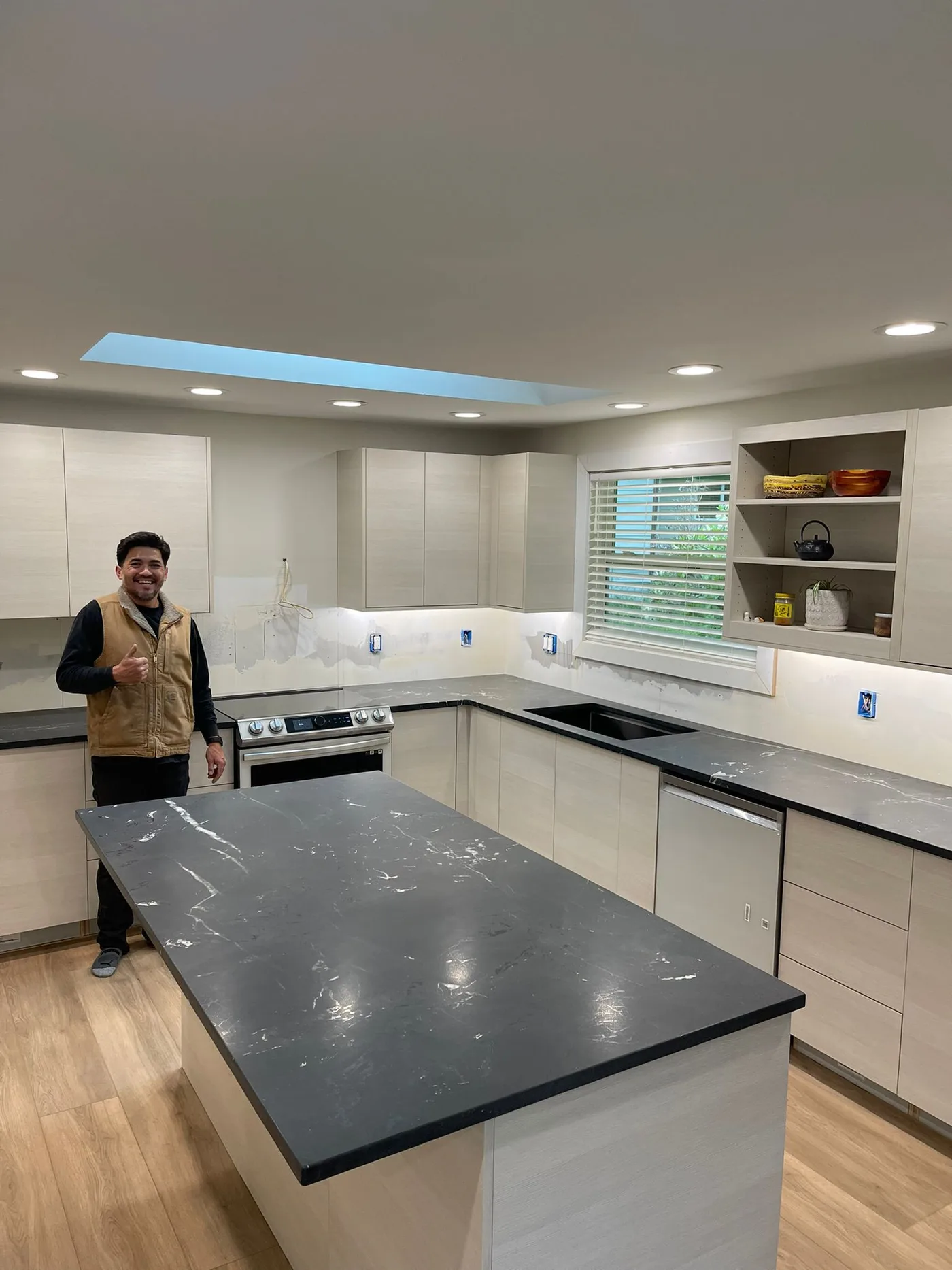Homeowner giving a thumbs-up beside their finished Top Granite countertop