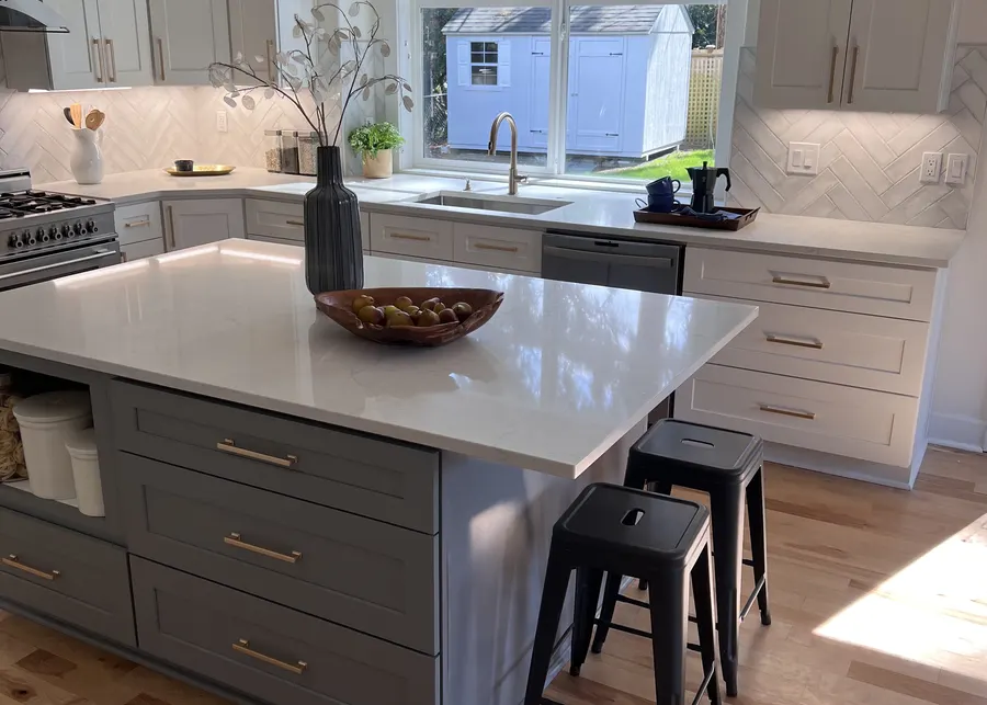 Grey island with seating and pendants. A Top Granite project