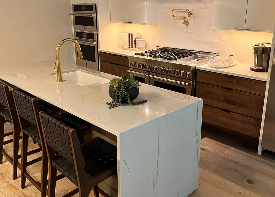 Marble island with wood cabinets. A Top Granite project