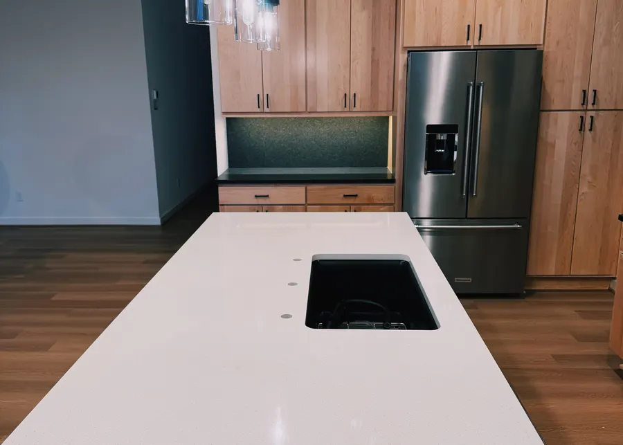 White island with pendants and maple cabinets. A Top Granite project