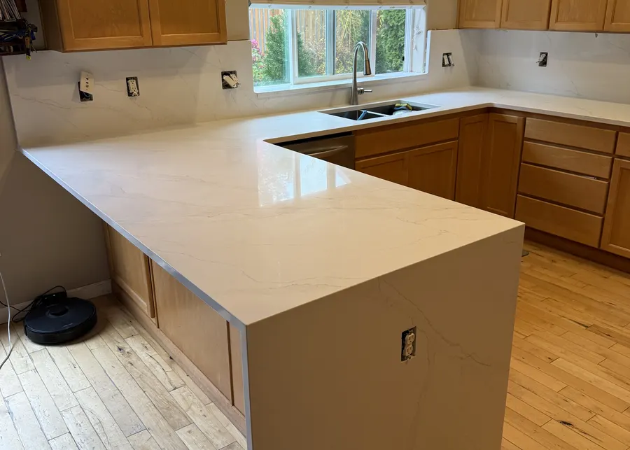 White peninsula with maple cabinets. A Top Granite project