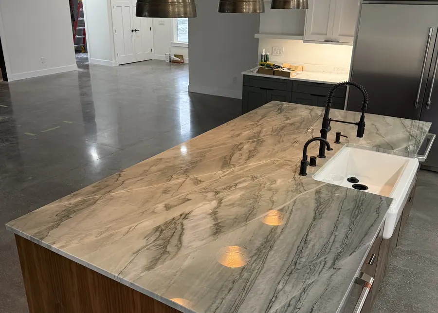 Quartzite island with a waterfall edge and walnut base. A Top Granite project