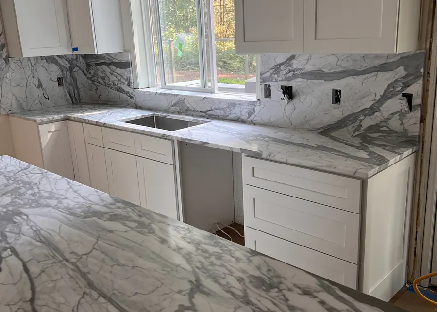 Dramatic marble with a farmhouse sink. A Top Granite project