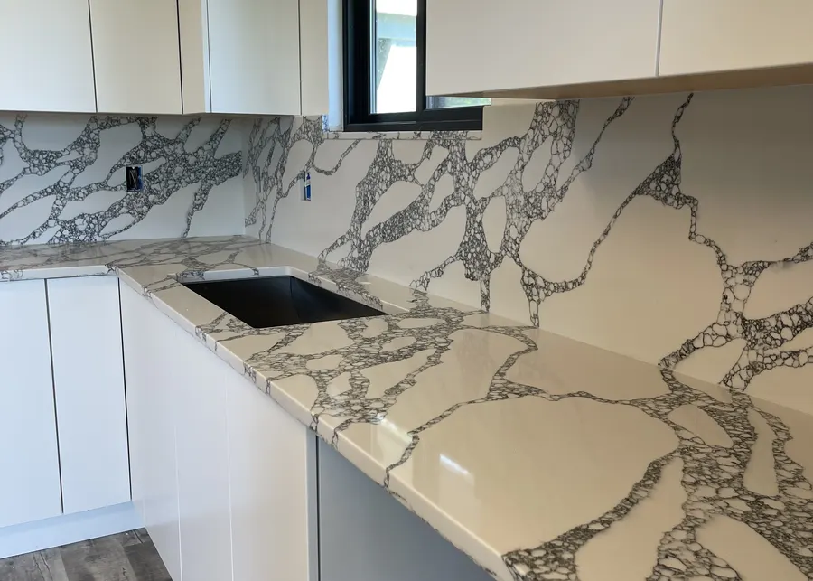 Calacatta with a full-height backsplash. A Top Granite project