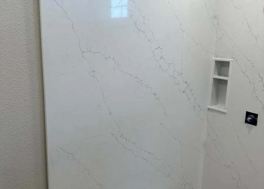 Full-height slab shower walls and vanities. A Top Granite project