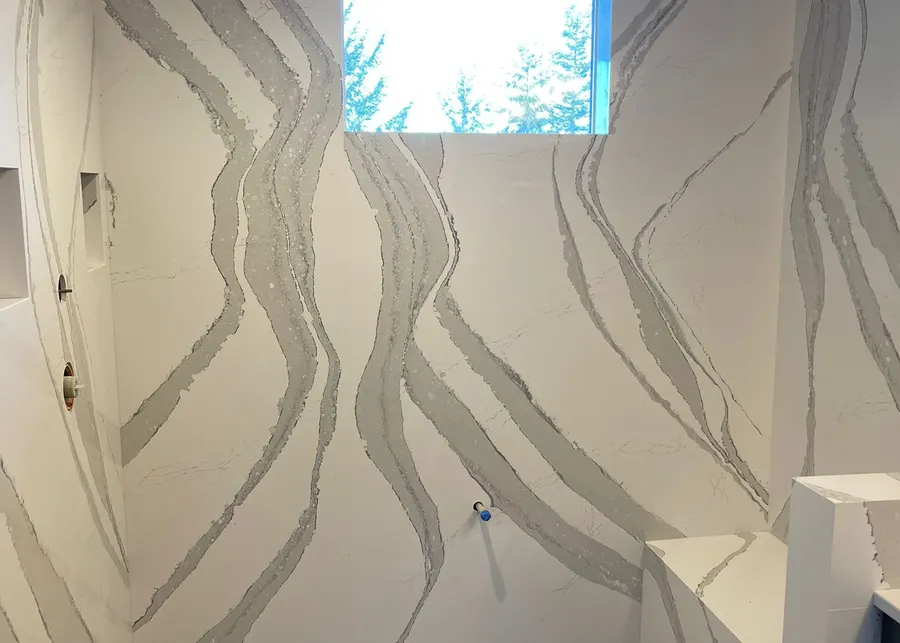 Full-height slab shower walls and vanities. A Top Granite project