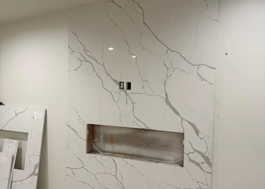 Full-height slab shower walls and vanities. A Top Granite project