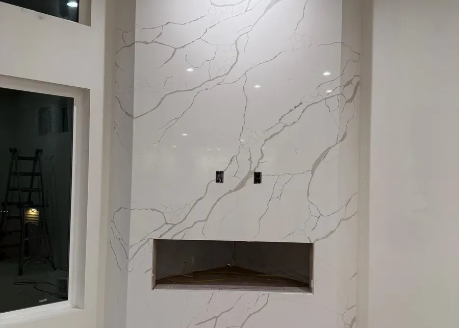 Full-height slab shower walls and vanities. A Top Granite project