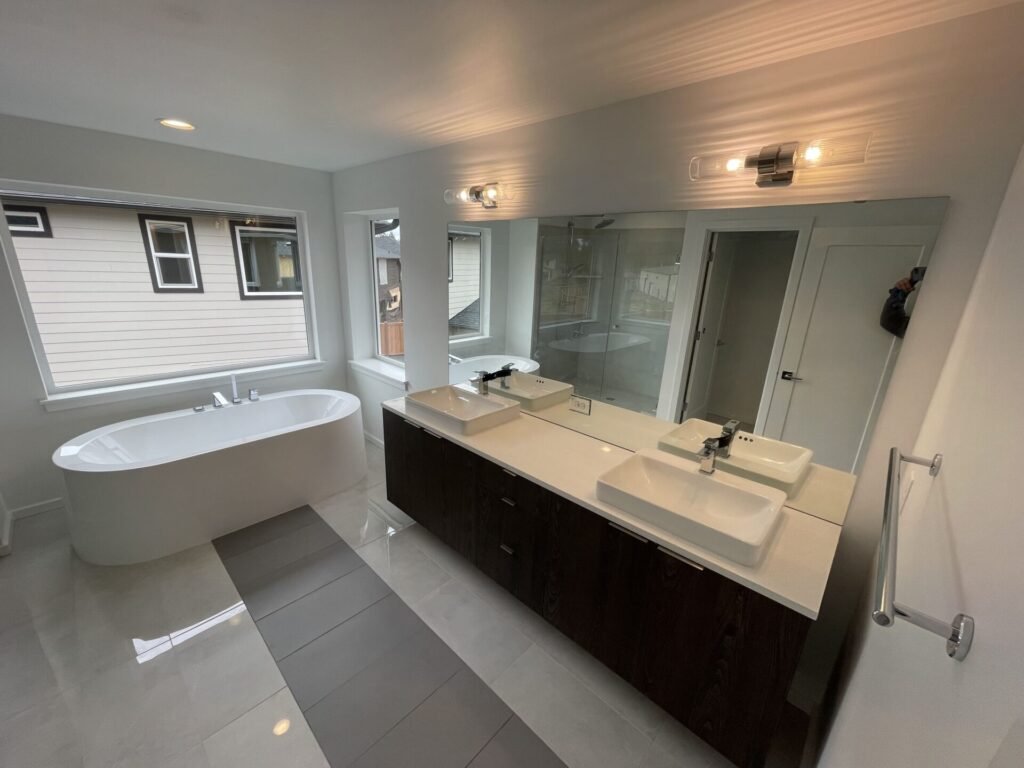 Completed Top Granite bathroom vanity beside a freestanding bathtub, shown as bathroom inspiration