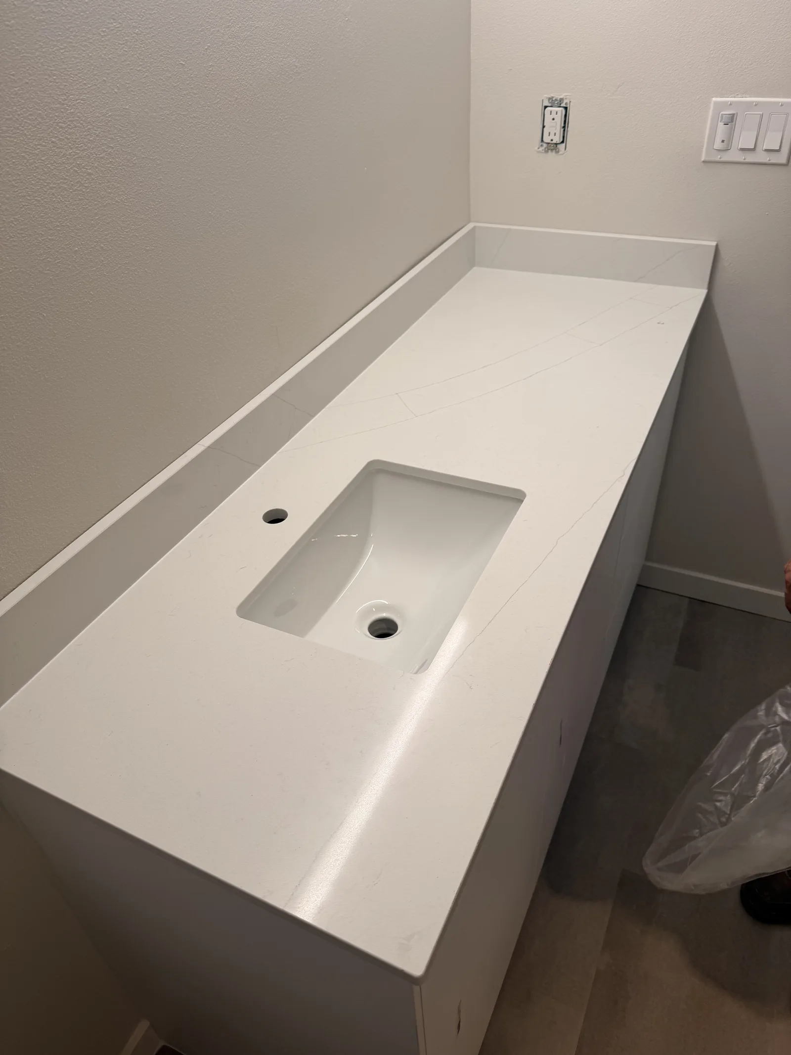 White quartz vanity top with an undermount sink, a Top Granite remnant project