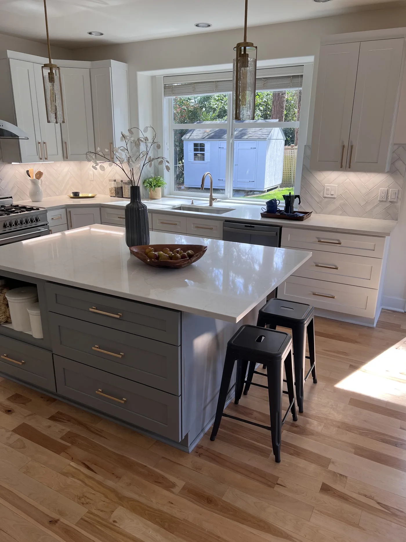 Grey island with seating and pendants. A Top Granite project