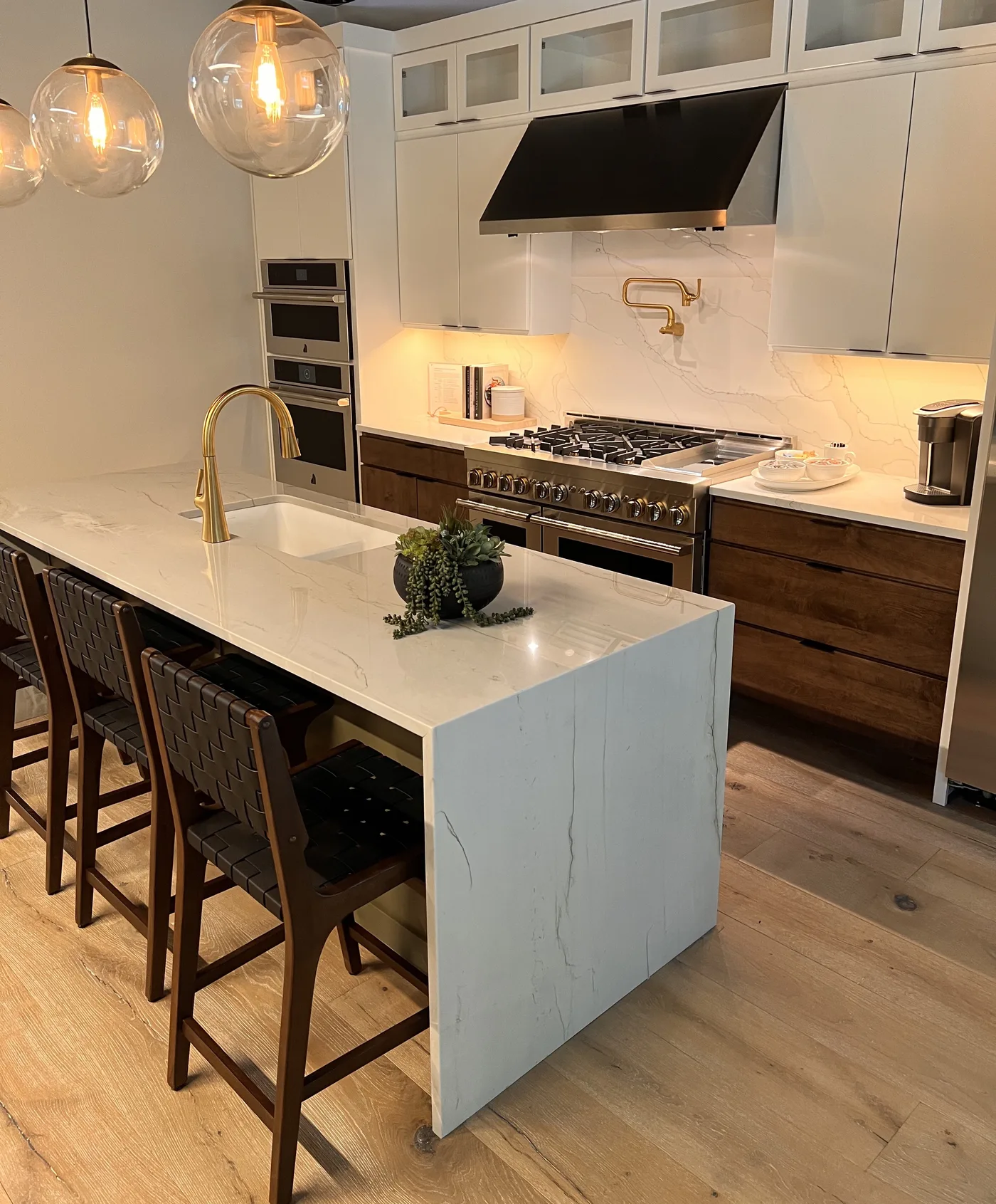 Marble island with wood cabinets. A Top Granite project