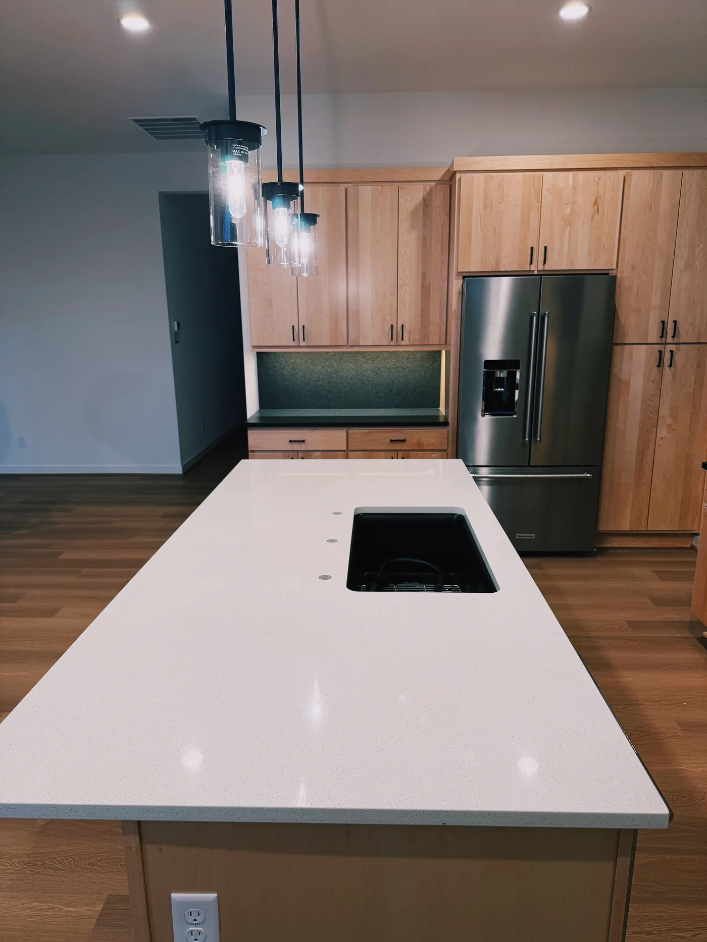White island with pendants and maple cabinets. A Top Granite project