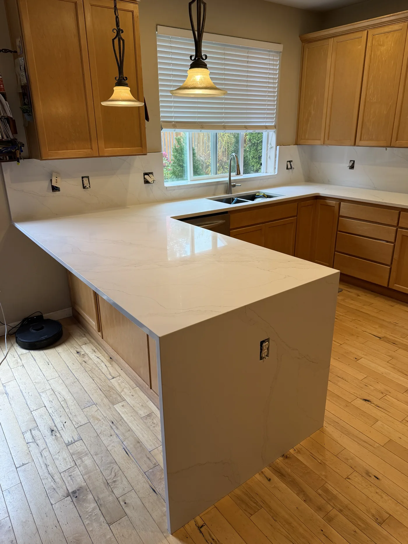 White peninsula with maple cabinets. A Top Granite project