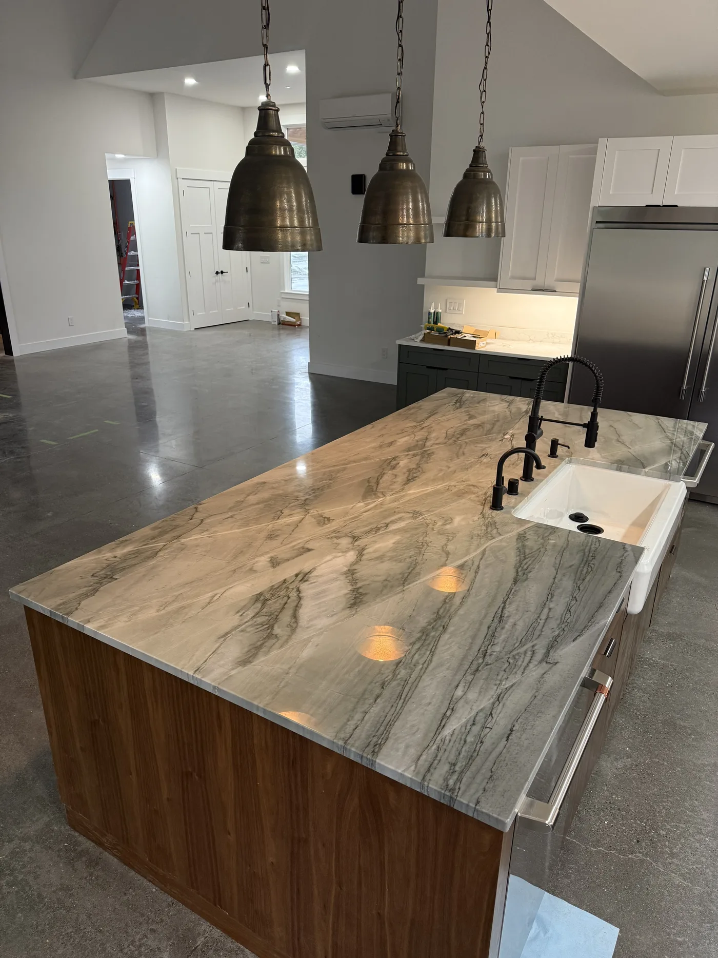 Quartzite island with a waterfall edge and walnut base. A Top Granite project