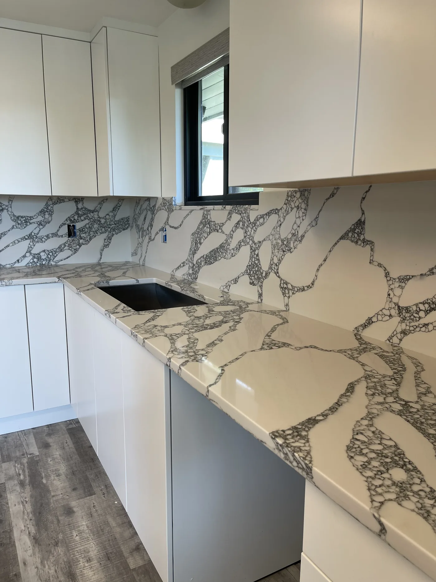 Calacatta with a full-height backsplash. A Top Granite project
