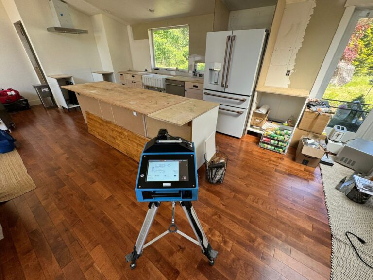 Laser templating machine taking precise kitchen countertop measurements for accurate granite, quartz, or marble fabrication